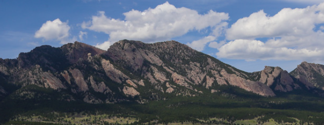 Foothills and blue sky with clouds