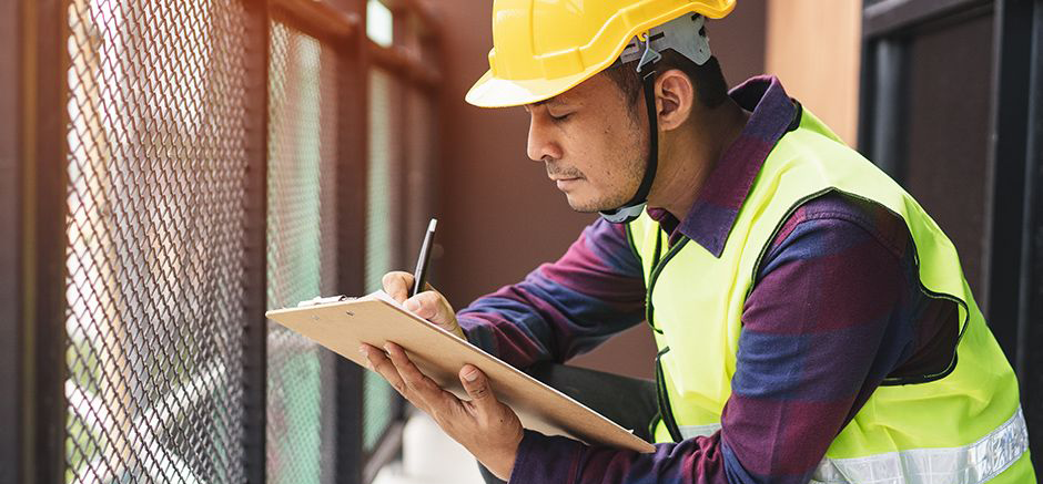 Image of an individual inspecting a building