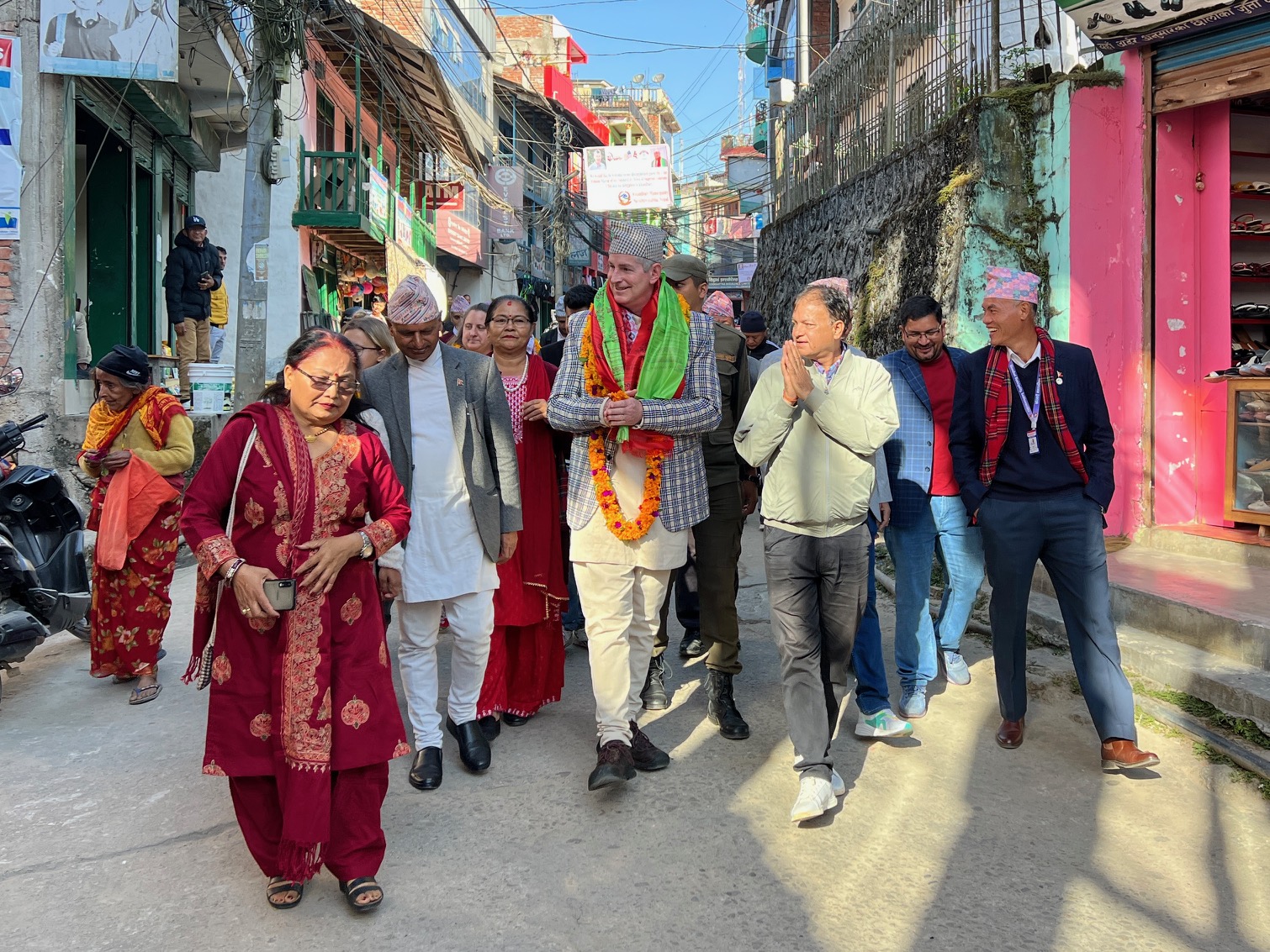 Mayor Fulsom walks down Khandbari streets with an escort from city officials.